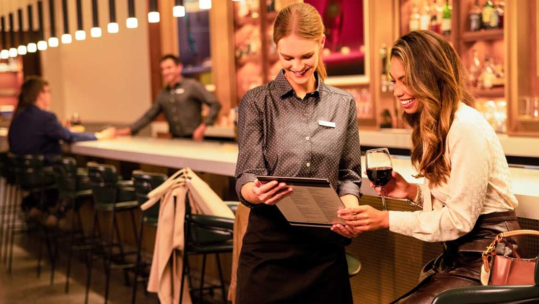 Omni server assists guest with a menu