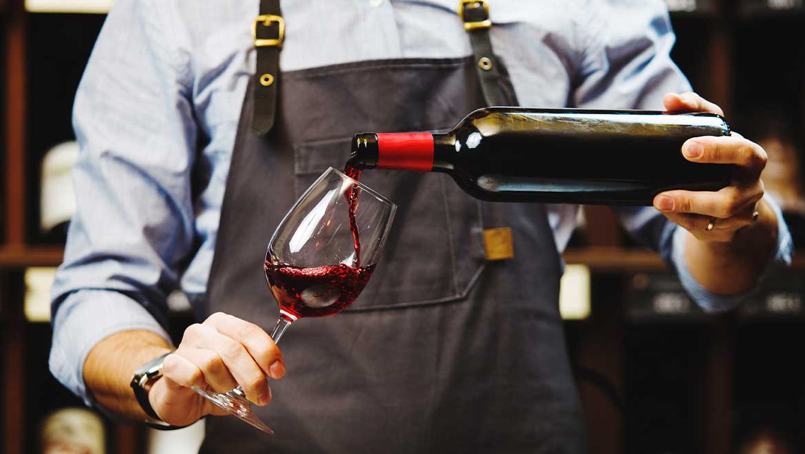 Bartender pouring a glass of wine
