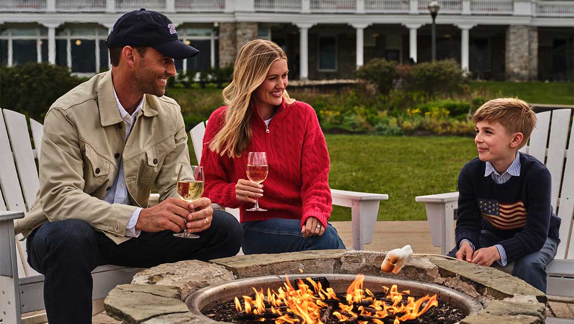 family sitting by  firepit