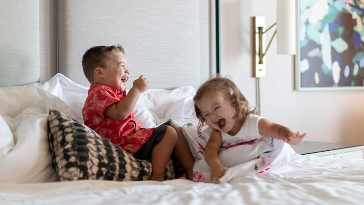 Kids laughing on the bed