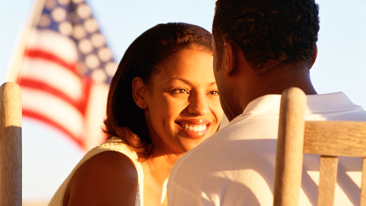 Couple with American flag in background