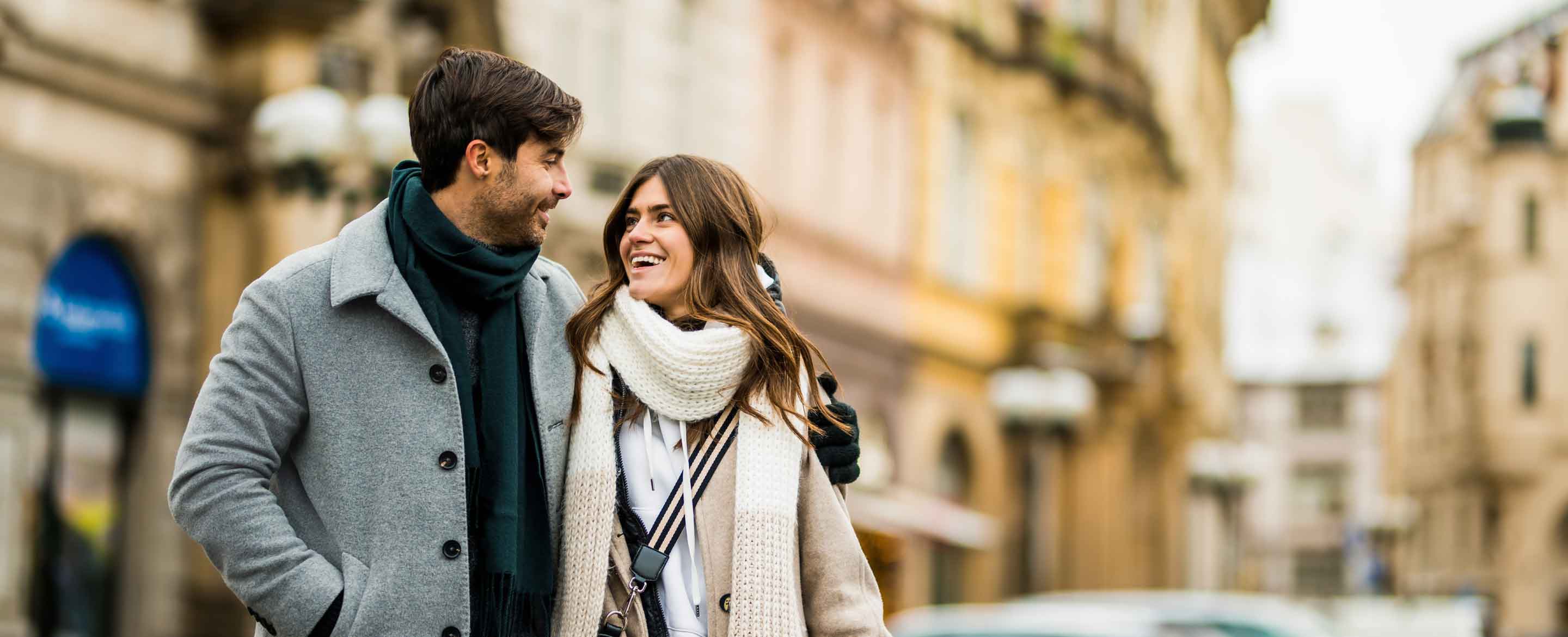 Couple walking through a city.