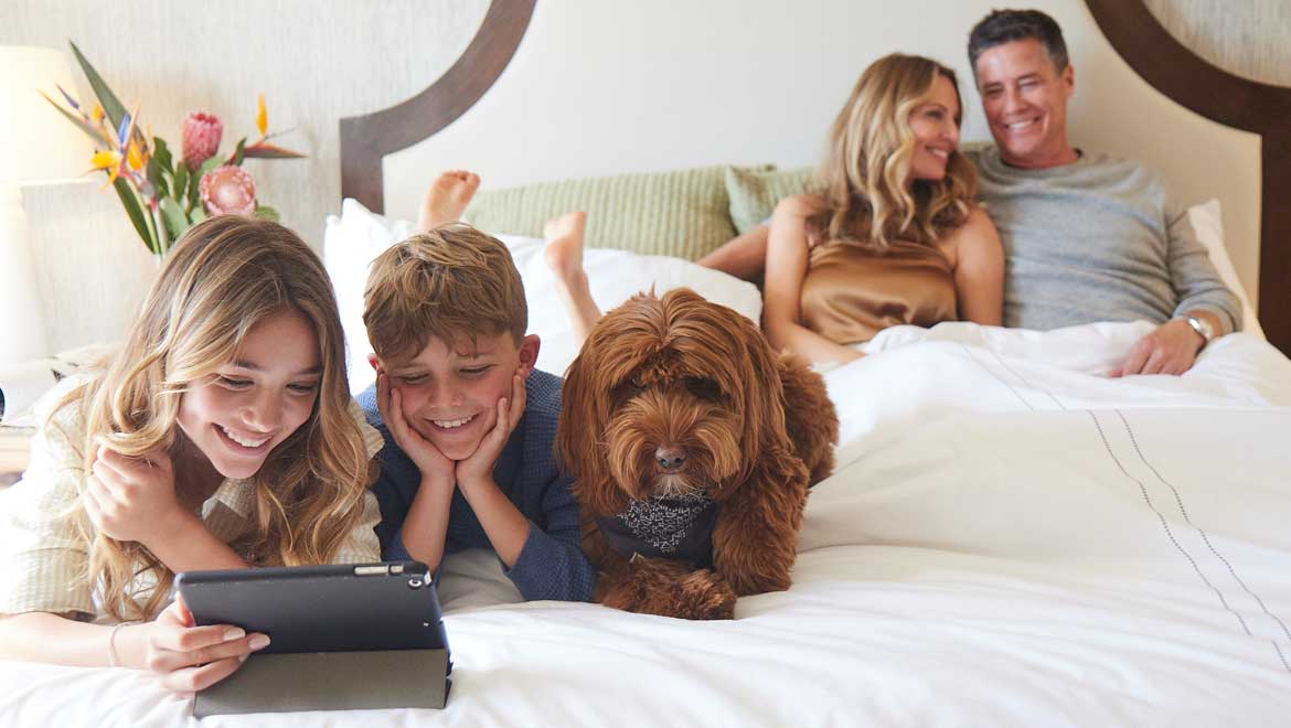 Family relaxing with their dog
