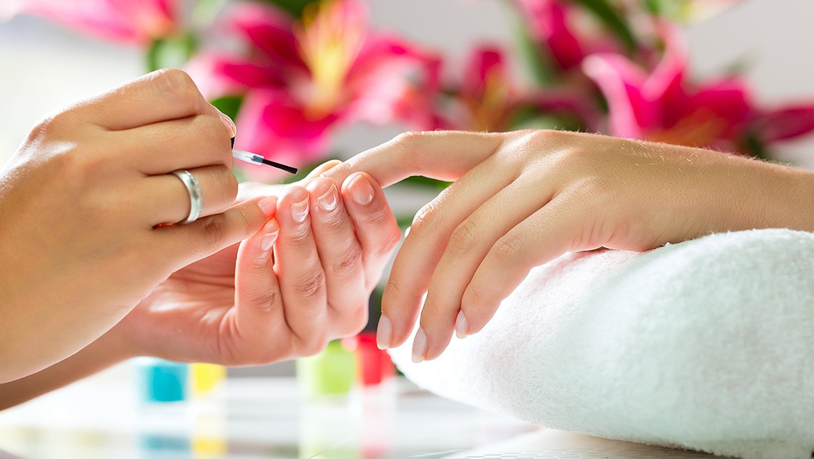 Woman getting nails painted.