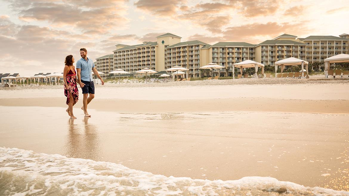 Couple walking on the beach.