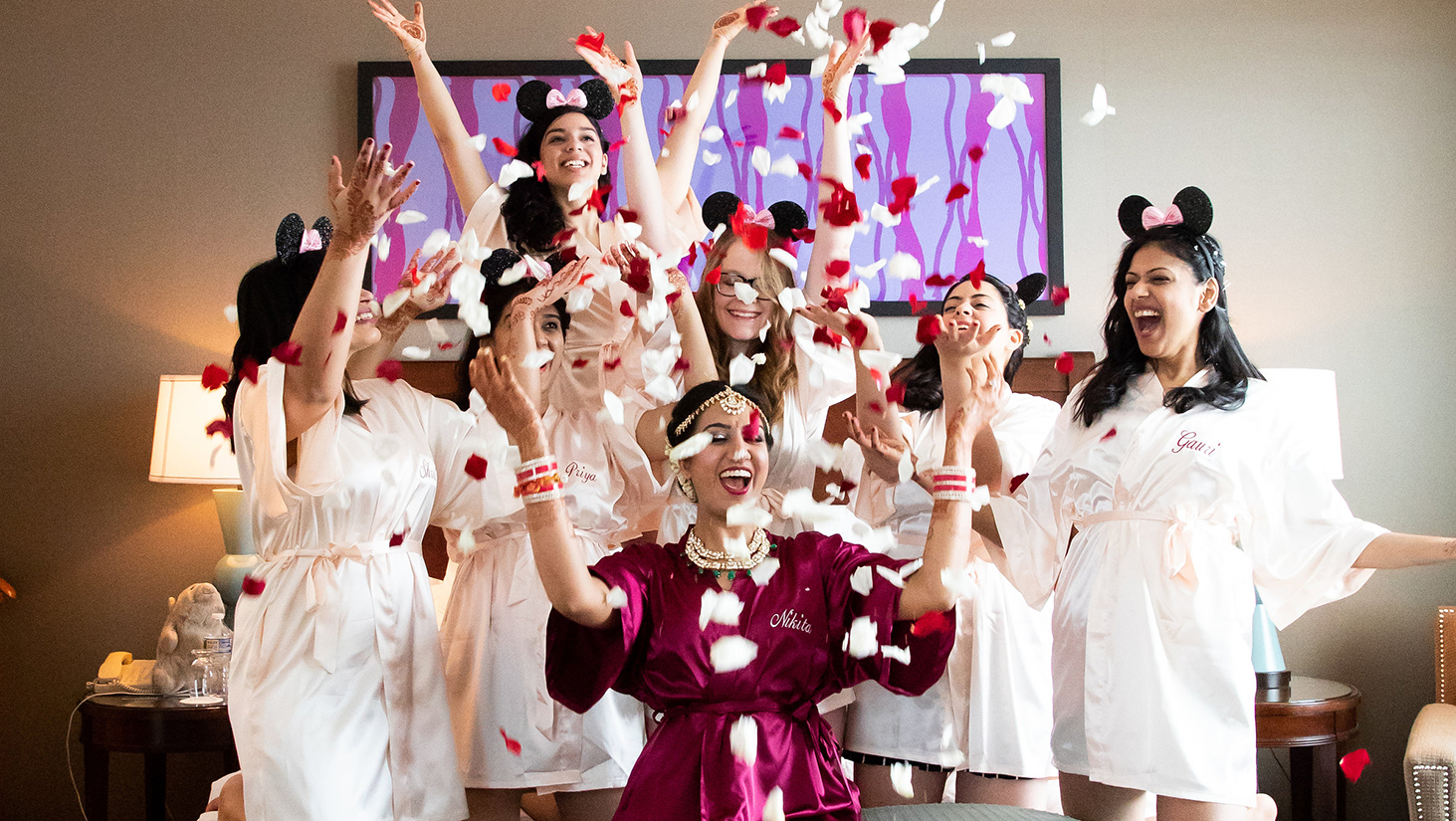 bride and her friends throw rose petals inside a room at omni atlanta 