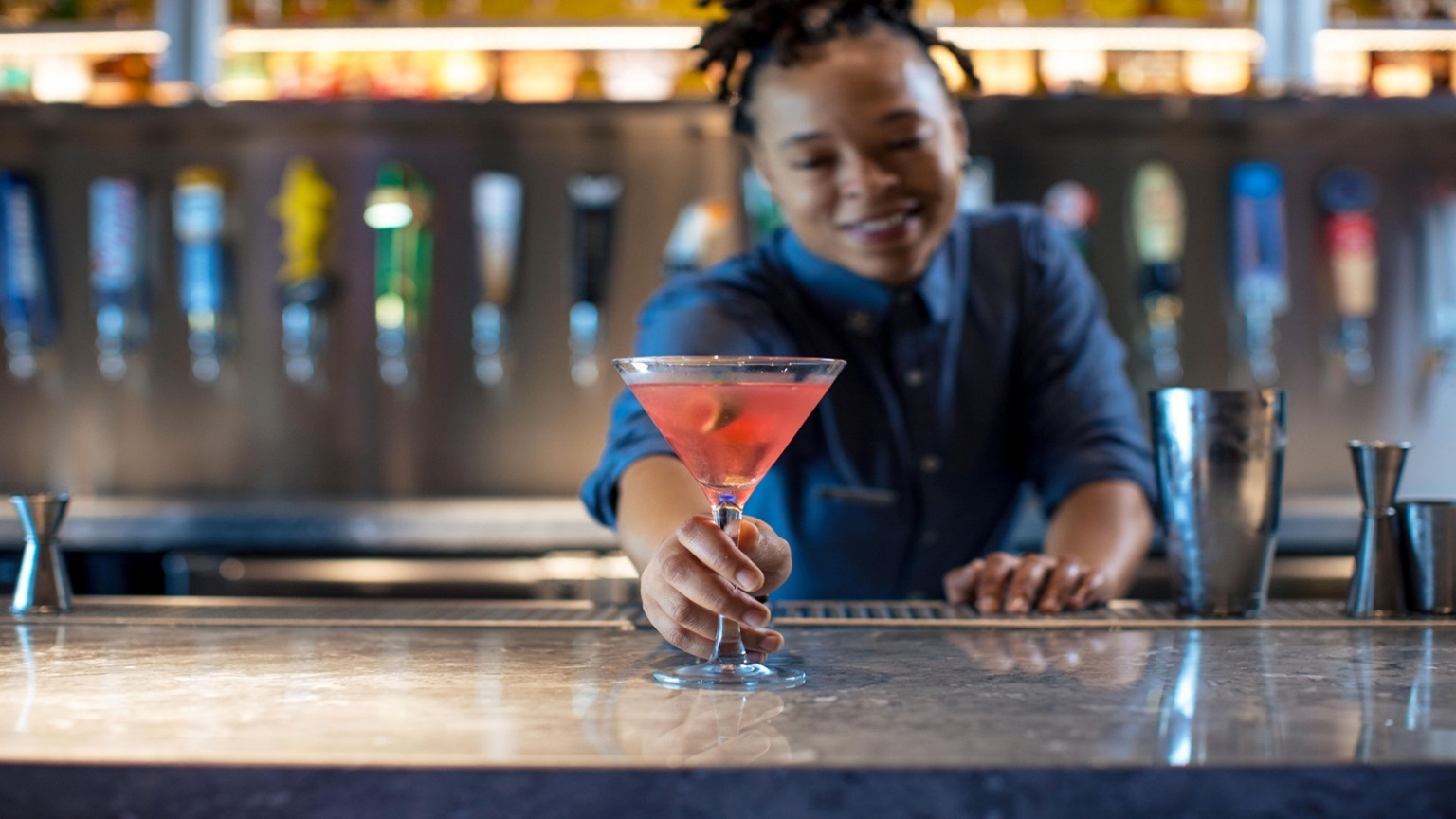 Bartender serving a cocktail.