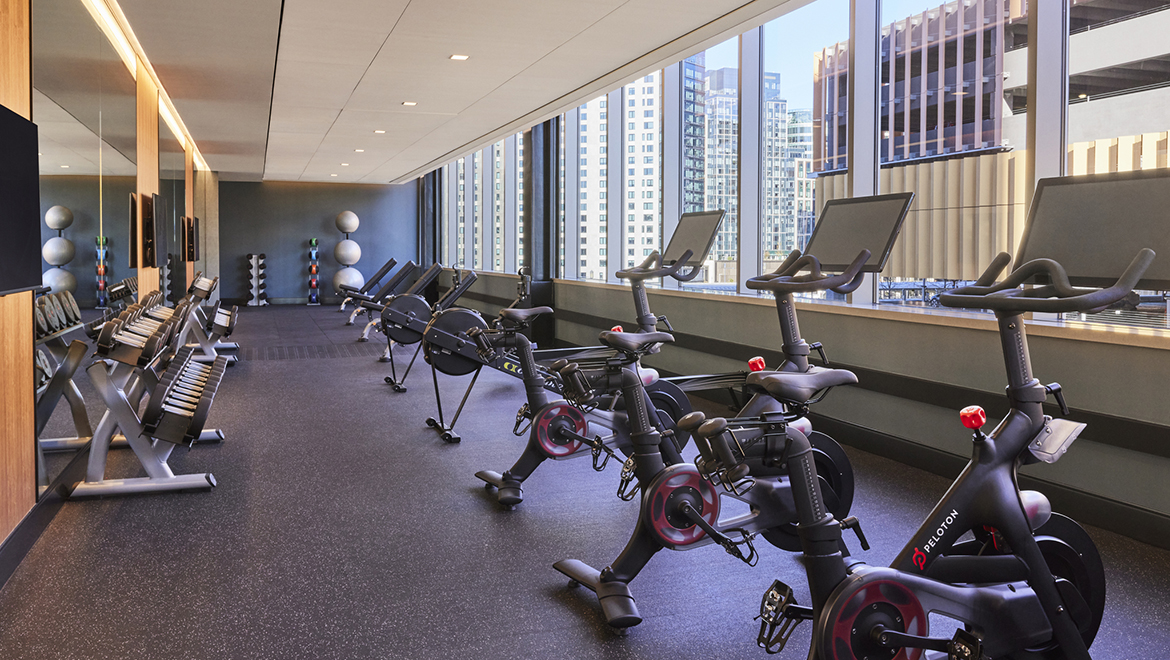The fitness center boasts tons of natural light, Peloton Bikes, rowing machines and more, located on the third floor - Omni Boston Hotel at the Seaport
