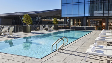 Scenic views and fire features await at the only rooftop pool in the Seaport - Omni Boston Hotel at the Seaport