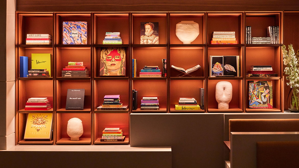 The bookcases in Kestra incorporate the performing arts and academic ties to Boston with literature - Omni Boston Hotel at the Seaport
