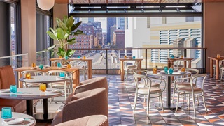 Lifted Pool Bar's fully retractable windows create a scenic Seaport terrace in just minutes - Omni Boston Hotel at the Seaport