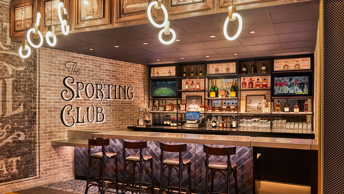 The Gymnasium Bar greets guests at The Sporting Club, featuring original flooring from the Boston Celtics' training facility - Omni Boston Hotel at the Seaport