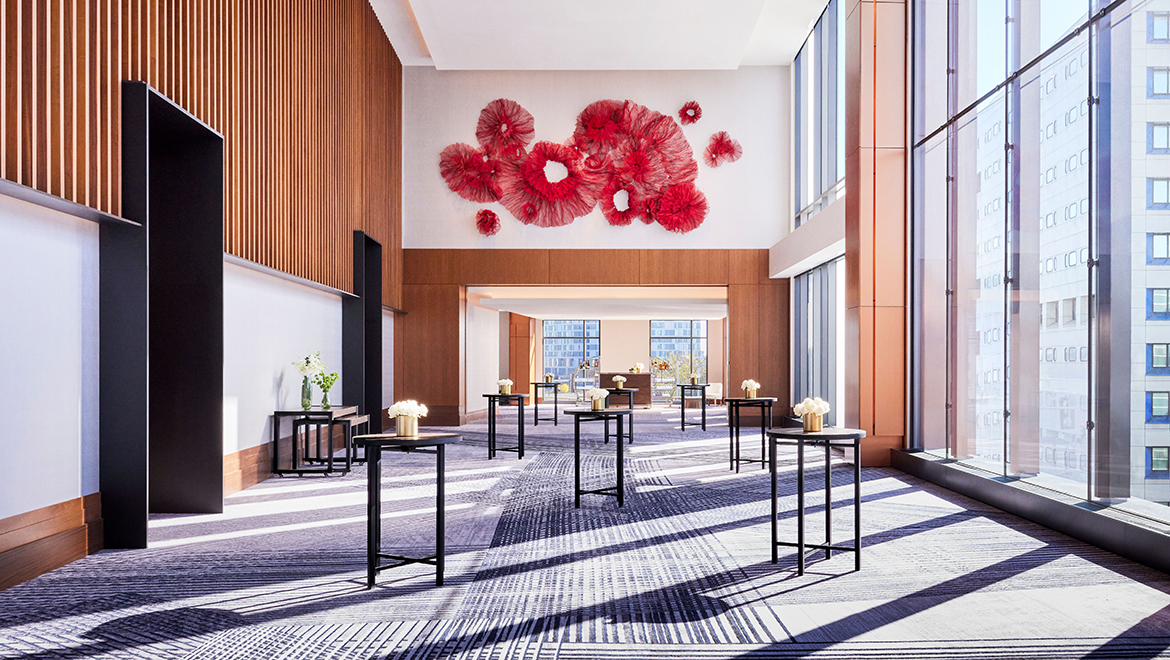The Ensemble ballroom prefunction space features a mesh metal monumental sculpture evoking a dancer's costume in motion - Omni Boston Hotel at the Seaport