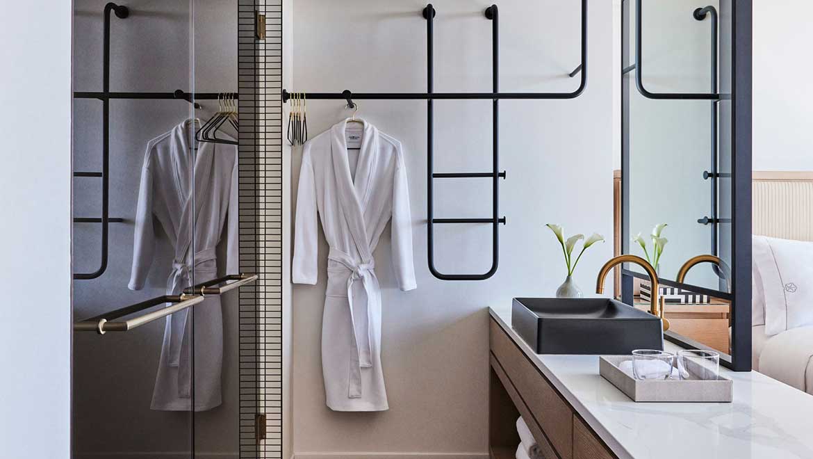 The frosted and mirrored bronze glass in the Artist Tower guest room bathroom provides privacy while artfully working with the minimalistic aesthetic of the space