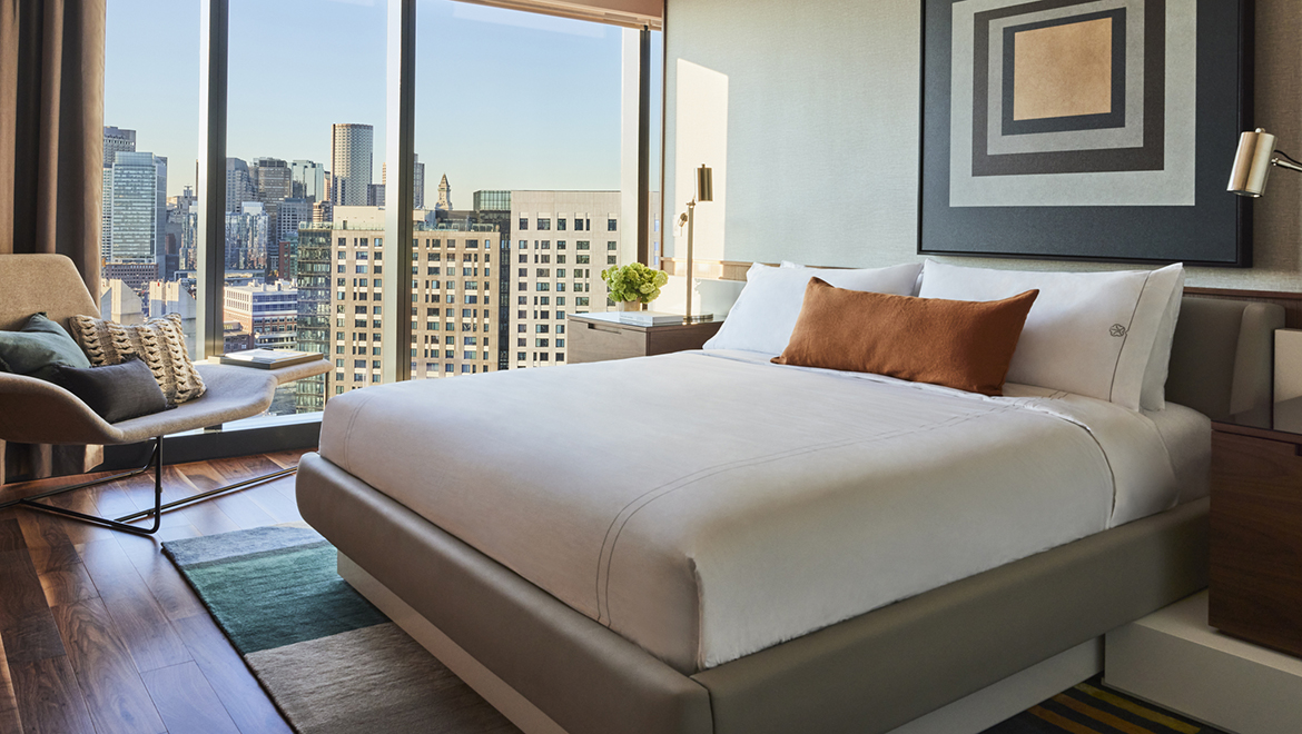 Located on the 22nd floor, the breathtaking views from Patent No. 2204 can be enjoyed throughout the suite including the master bedroom and walk-in closet - Omni Boston Hotel at the Seaport