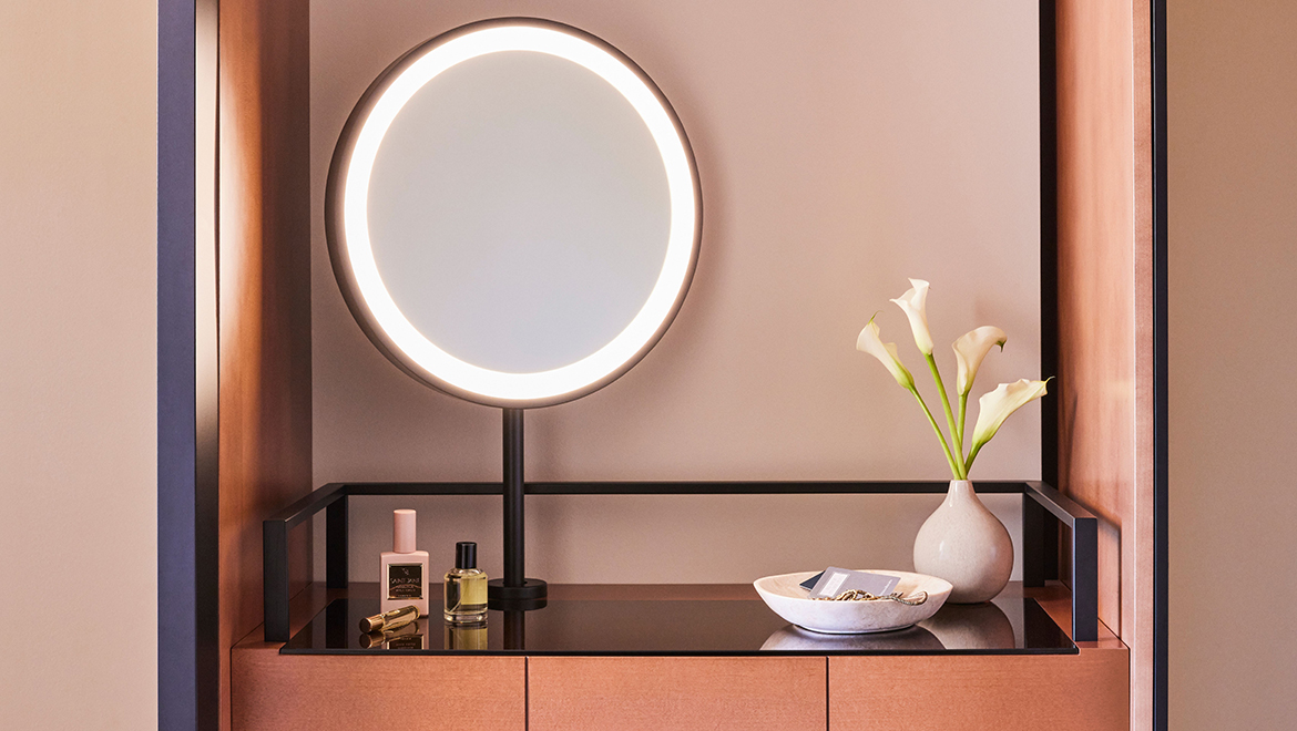 Custom closets with full length bronze mirrored fronts and a vanity with lighted mirror are luxurious details found in Patron Tower guest rooms - Omni Boston Hotel at the Seaport