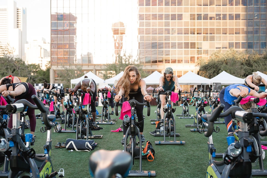 People riding stationary bikes.