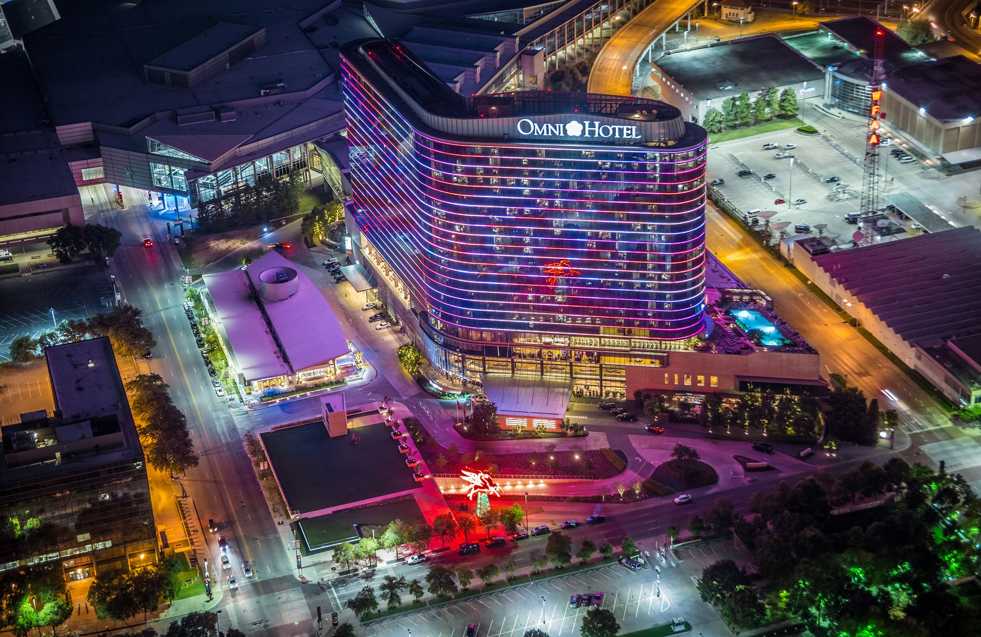 Omni Dallas Hotel glowing at night in downtown Dallas