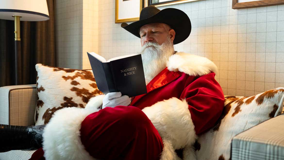 Santa reading the naughty and nice book.