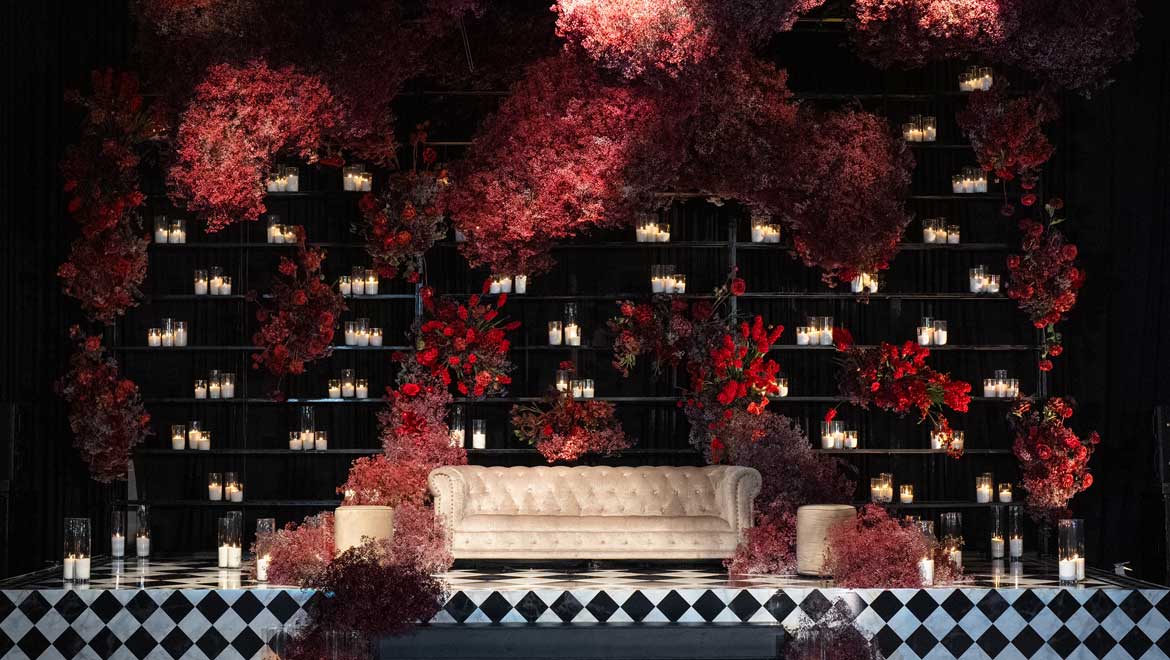 Stage with couch and candles.