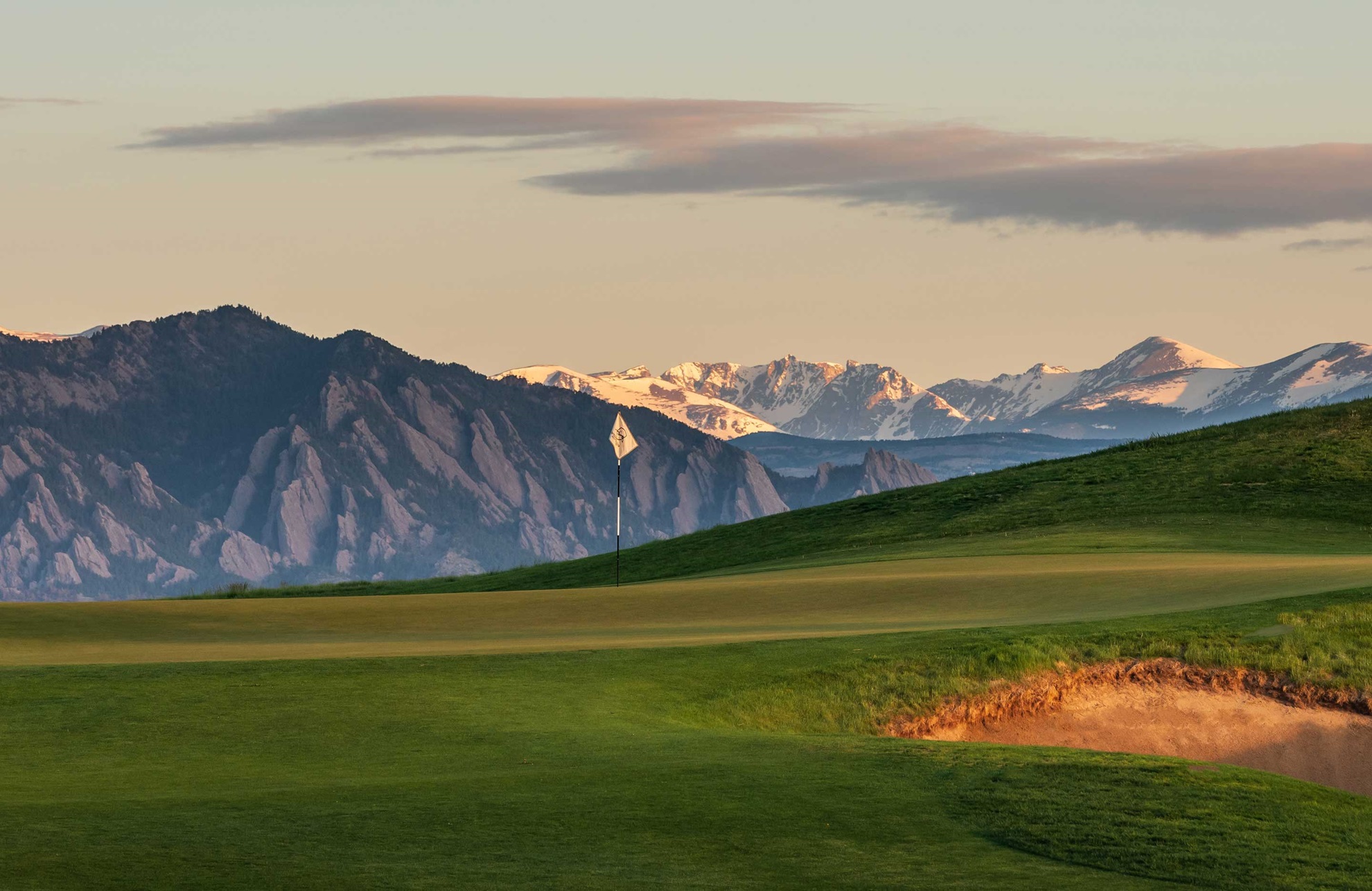 Beautiful golf course with view of snow capped mountains.