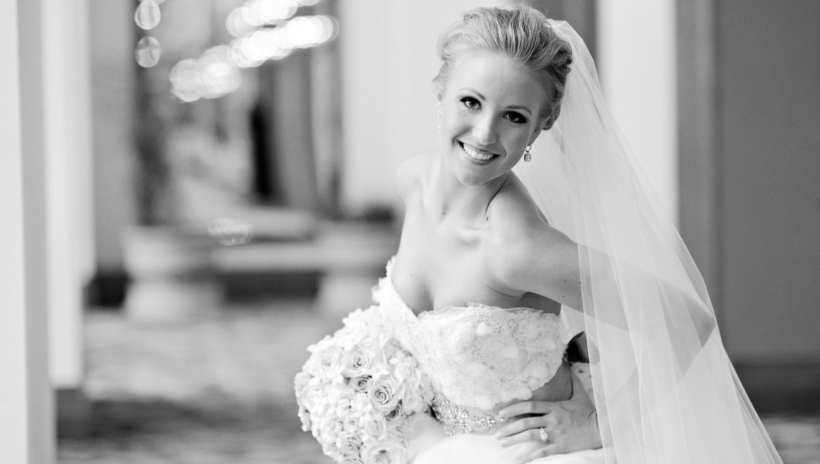 Bride smiling with bouquet