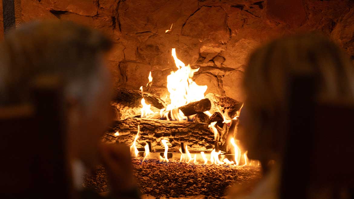 couple sitting by the fireplace