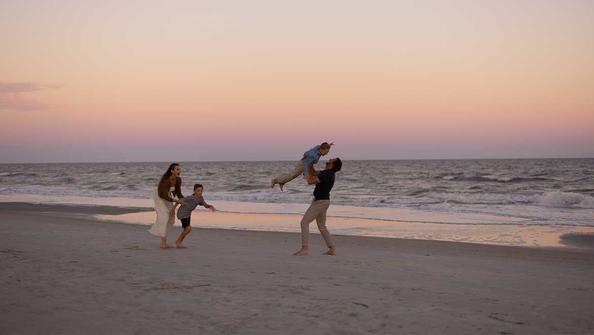 family playing on the beach