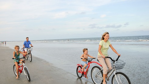 Family riding bikes on the sugar sand beaches of Hilton Head Island