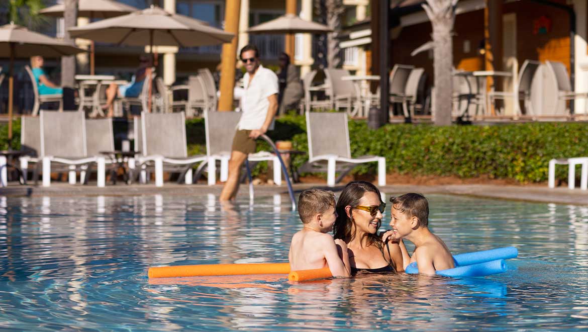 Mom and kids swimming in the pool