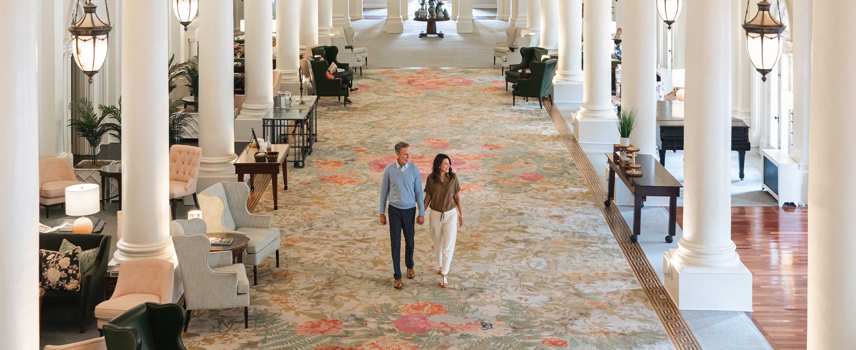 Couple walking through hotel lobby