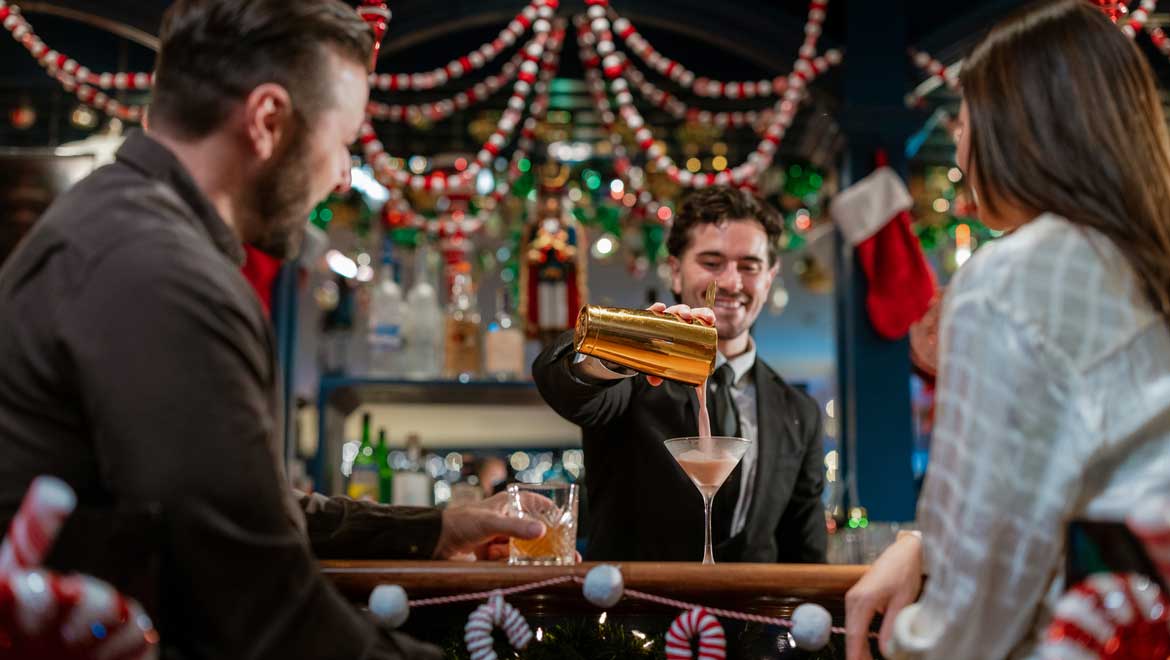 Bartender pouring holiday drink.