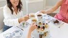 People toasting tea cups.
