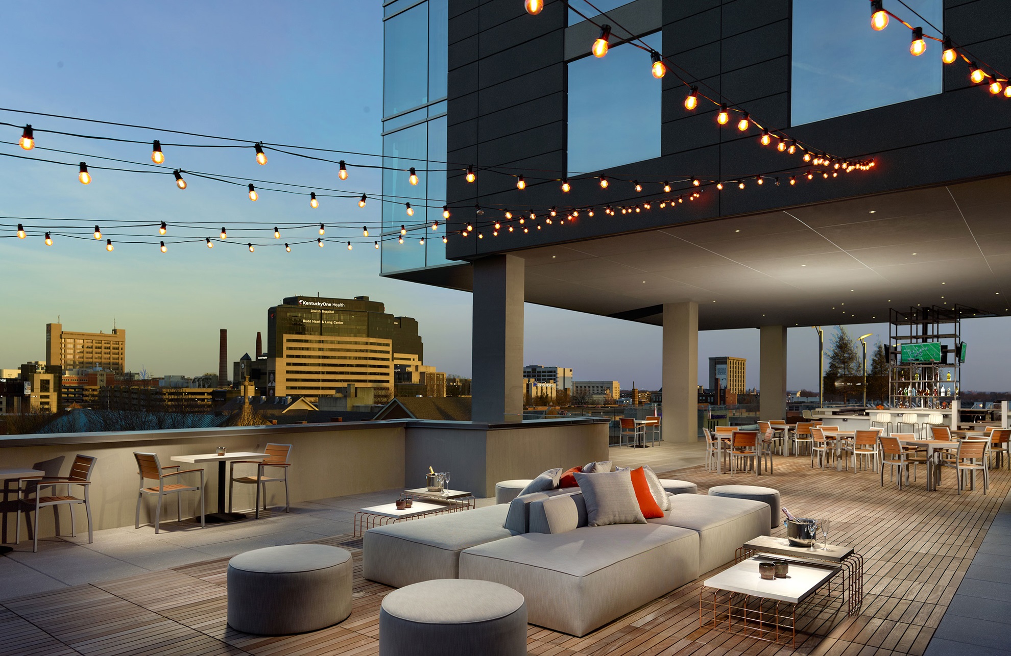 Beautiful terrace with luxurious seating and view of the city.