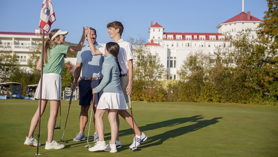 Mom celebrating with family on golf course at Omni Mount Washington Resort & Spa