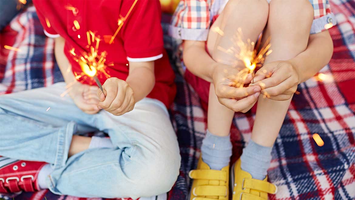 kids holding sparklers