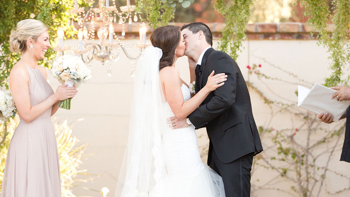 Bride and groom kiss at ceremony