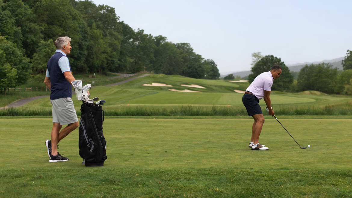 Man teeing off.