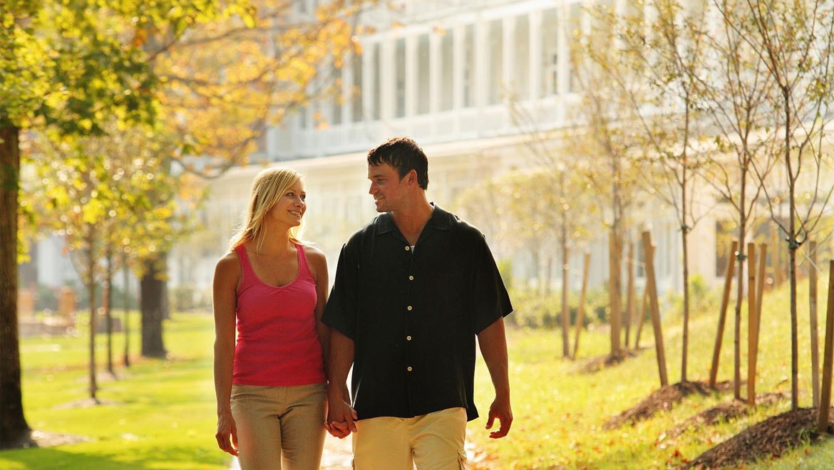Couple walking through the park in Bedford Springs