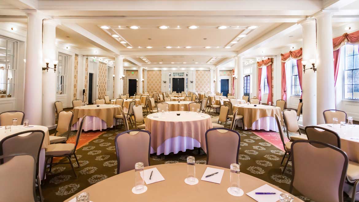 Large room with round tables. 