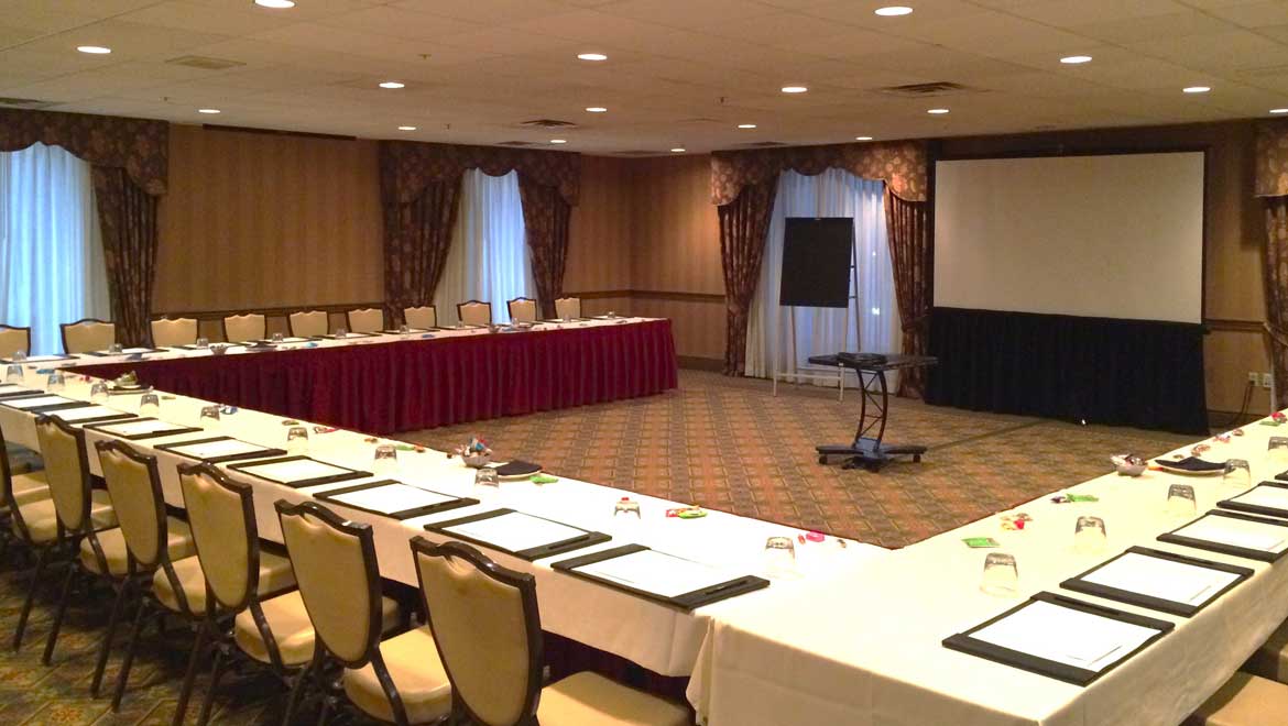 Conference room with horseshoe table set up.