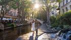 couple walking along riverwalk