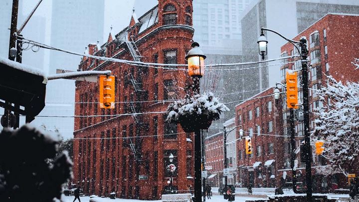 Snow falling downtown.