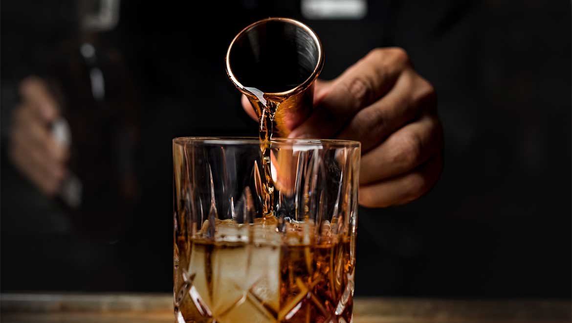 Bartender pouring out drink
