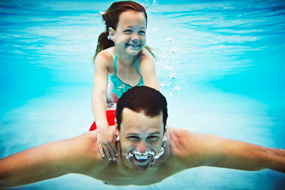 father and daughter swimming