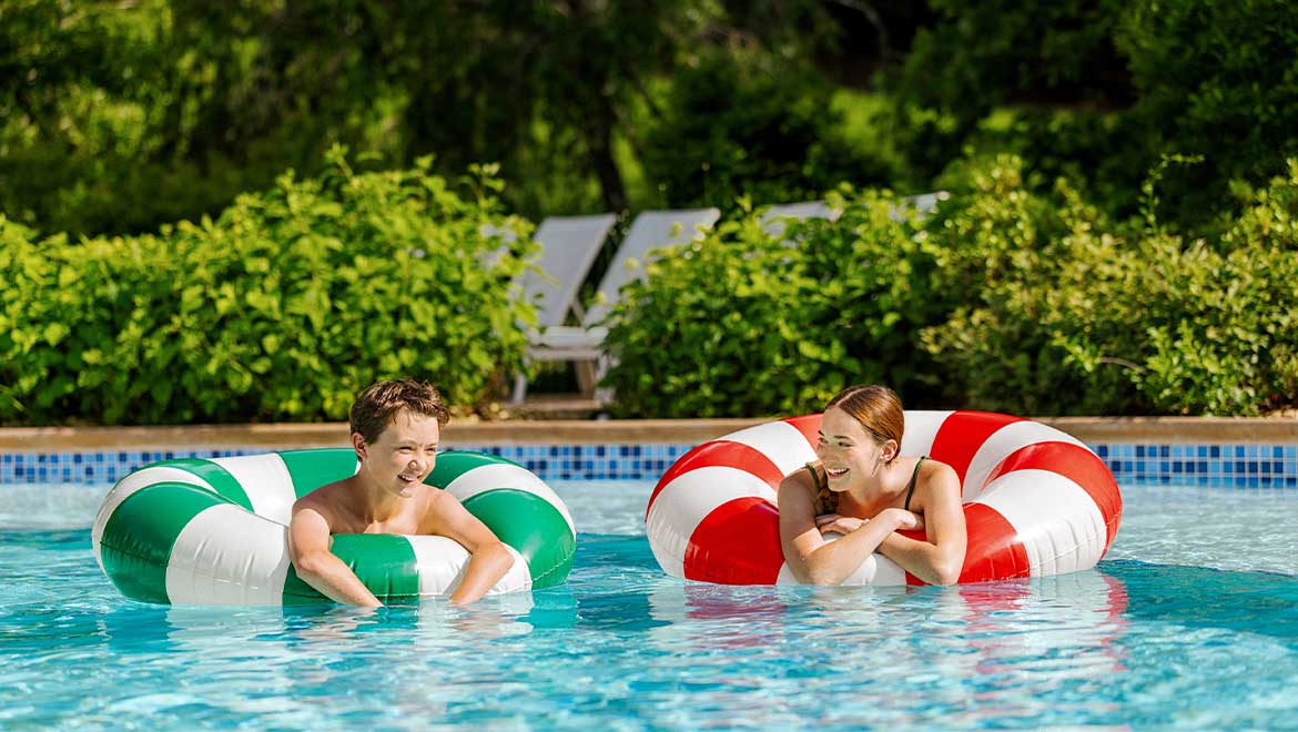 Kids floating in the pool